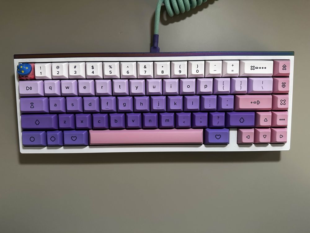 Tofu 65 keyboard with purple and pink gradient keycaps. Sleeping Kirby is the escape key
