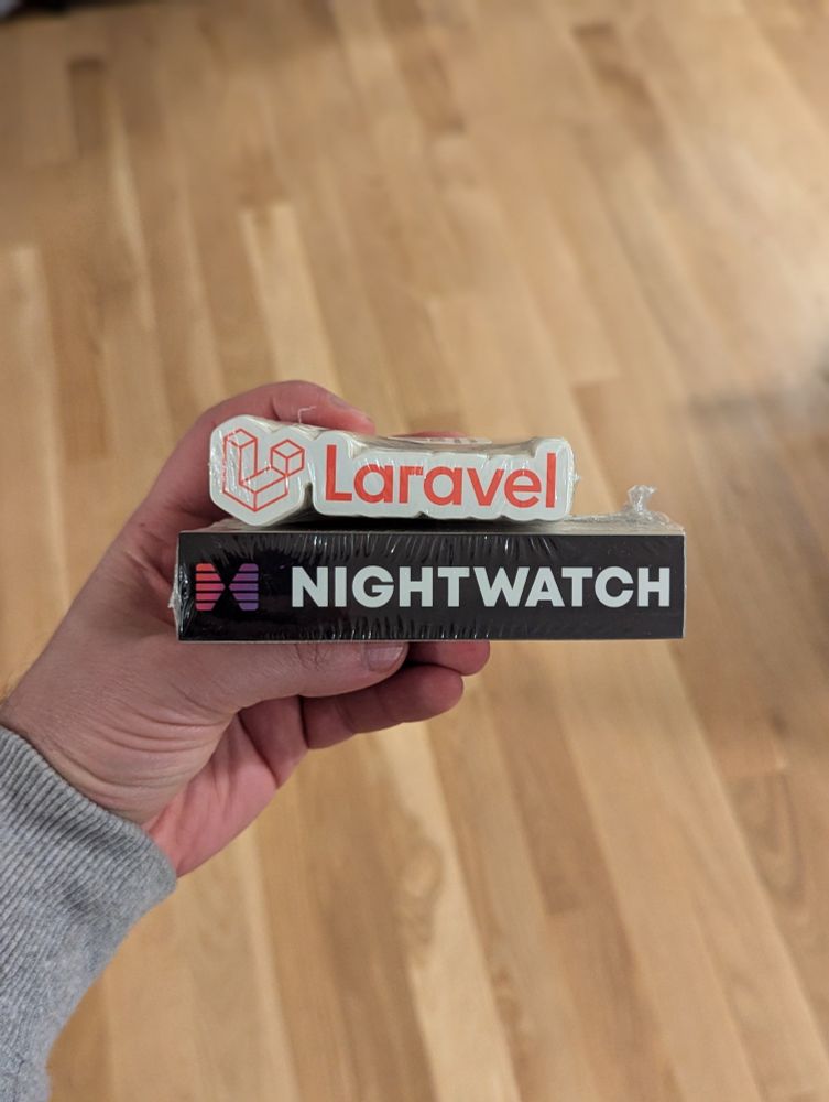 Stack of Laravel and Nightwatch stickers