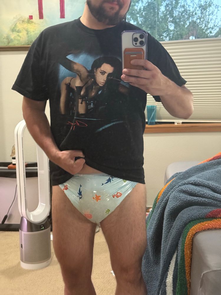 Man standing in mirror wearing a sea themed diaper