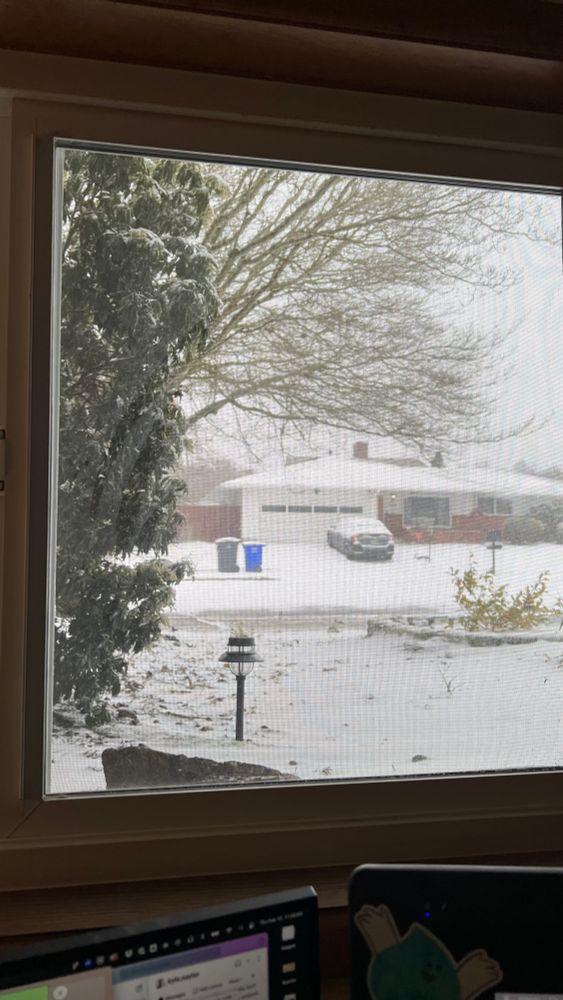 A view of the snowy street in the suburbs of Portland. 