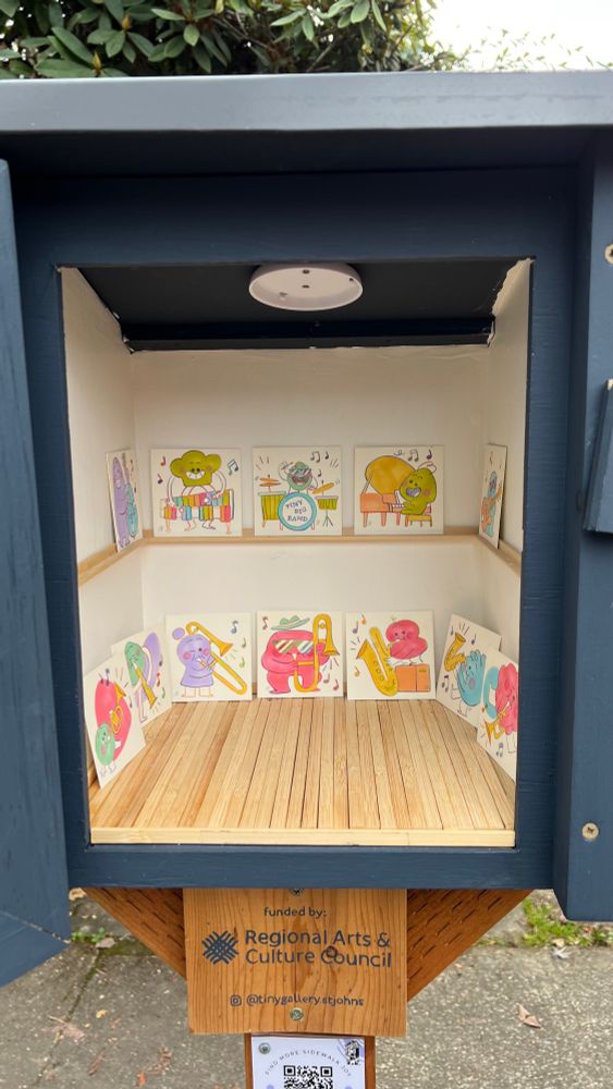 12 colorful miniature pieces of art (3x3”) of playful characters in a jazz band displayed in a small enclosure like an art gallery