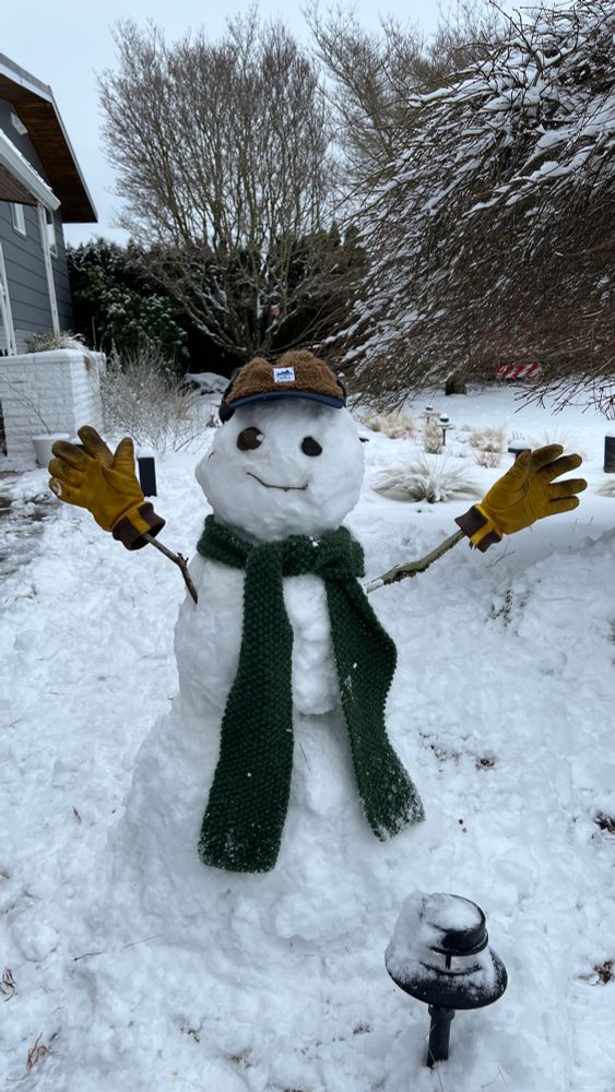 Hand made snowman with a scarf gloves and a hat 