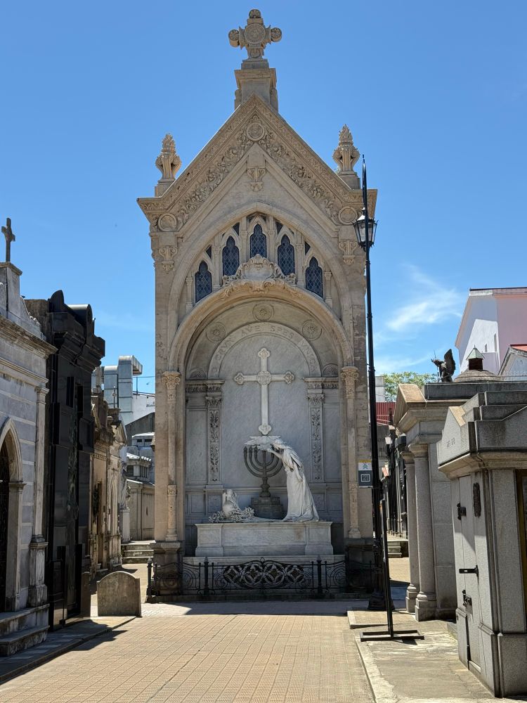 A huge mausoleum at La Recoleta cemetery is n a beautiful blue sky day Halloween 2025