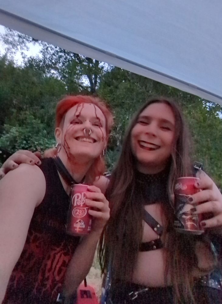 Jenn and Mars sharing post-set Dr. Peppers, blood dried all over Mars' face