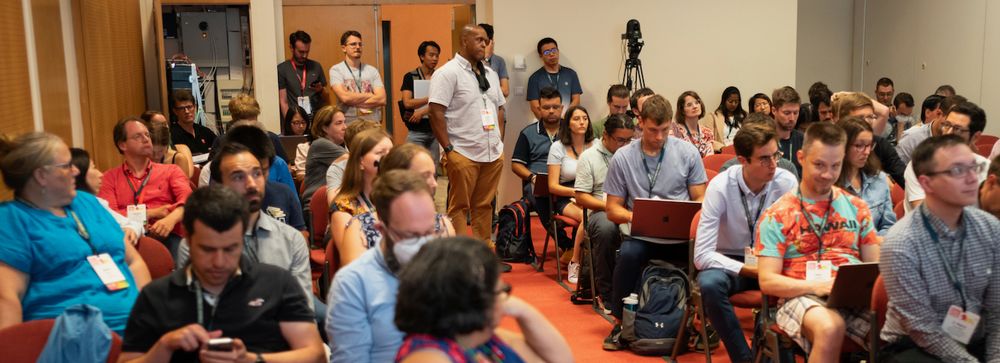Part of the audience at BOSC 2023, with Jason Williams standing in the center aisle