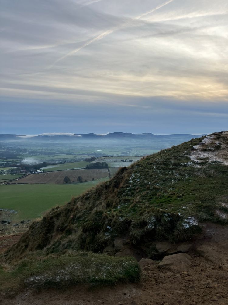 Misty sunset over frosty moorland