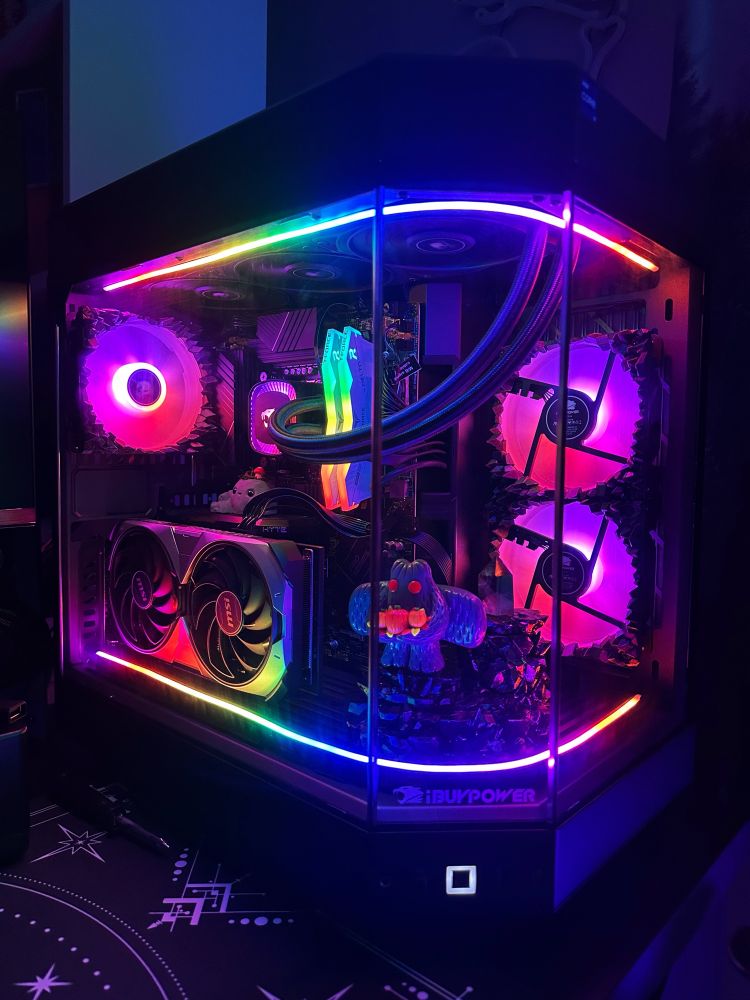 Hyte y60 PC case with tons of RGB and a mothman figure inside the fishbowl viewing area