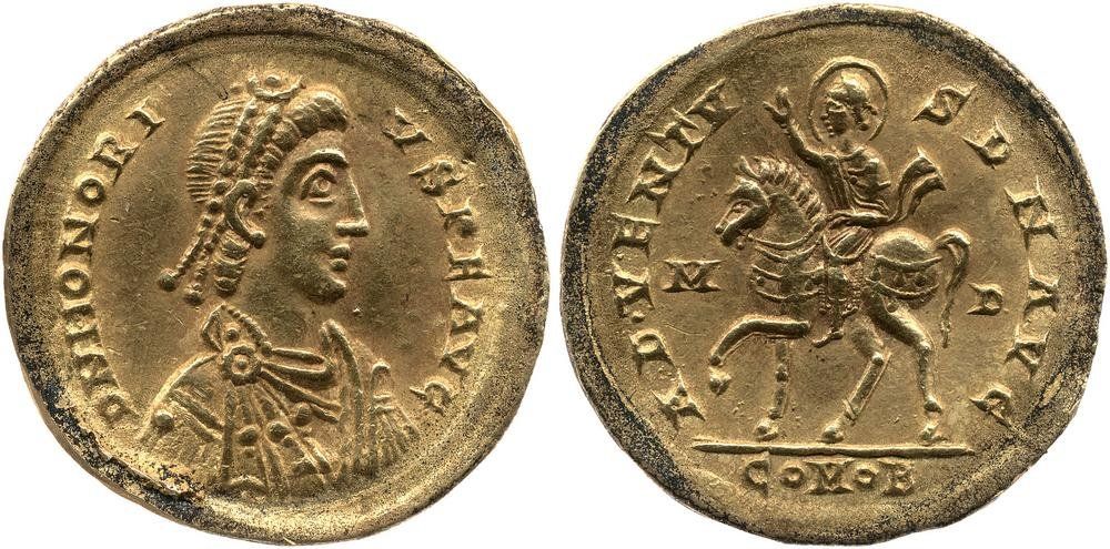 A Roman gold coin. Obverse:  Bust of Honorius, pearl-diademed, draped, cuirassed, right; Reverse: Honorius, nimbate, draped, cuirassed, riding left, raising right hand.