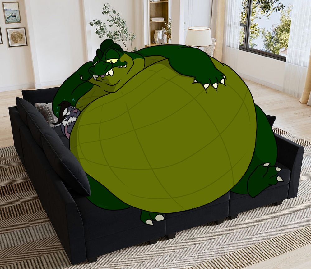 Wani on the picture of the modular couch, with Nezumi nestled under his belly.
