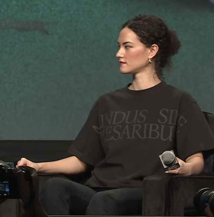 Jay Graber, Bluesky CEO, wearing a black shirt that says mundus sine caesaribus.