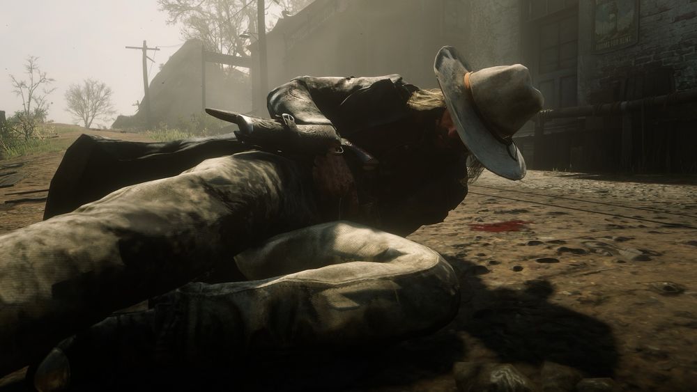 Micah Bell writhing around on the ground in Van Horn after I shot him with explosive ammo, he’s covered in dirt and blood.
