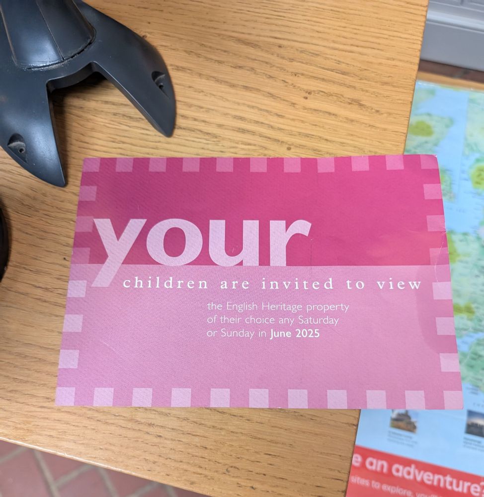 A pink voucher which says "your children are invited to view the English Heritage property of their choice any Saturday or Sunday in June 2025"