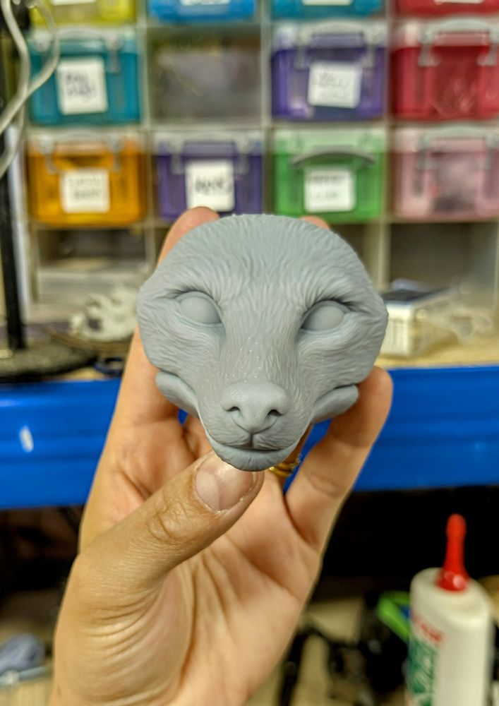 A grey, 3D printed fox doll head
