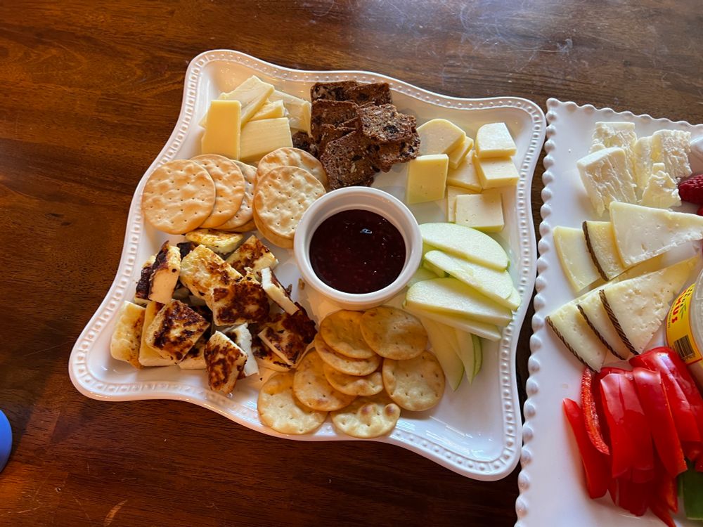 Crackers, raspberry preserve, cheese, sliced apples 
