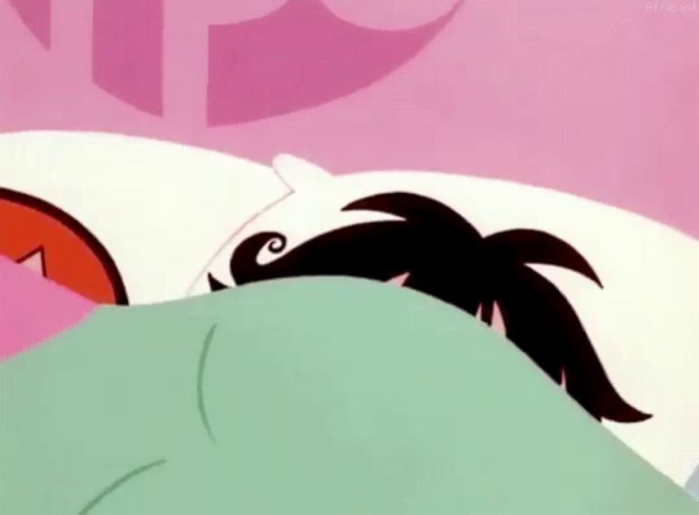 buttercup from the powerpuff girls is laying in bed under a blanket with a sad look on her face .