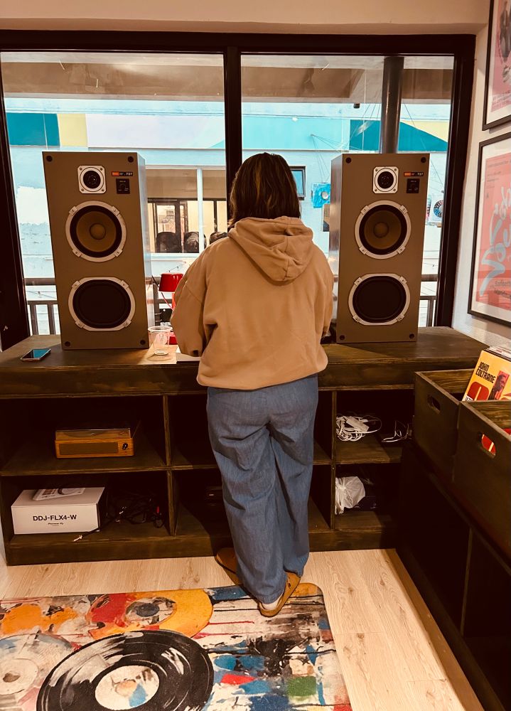 Double speakers and DJ setup with Kara mixing by the window