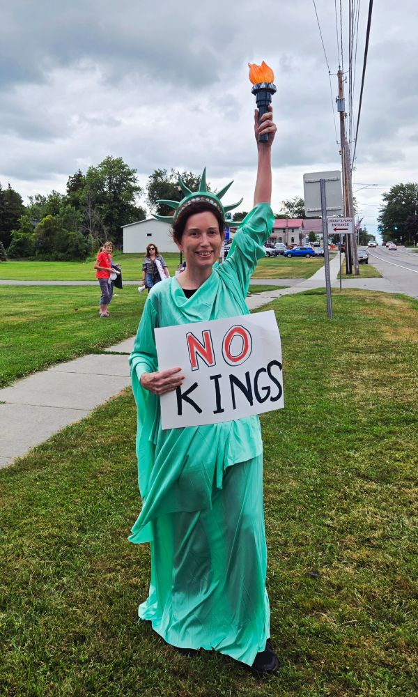 Lady Liberty with a sign saying "NO KINGS"