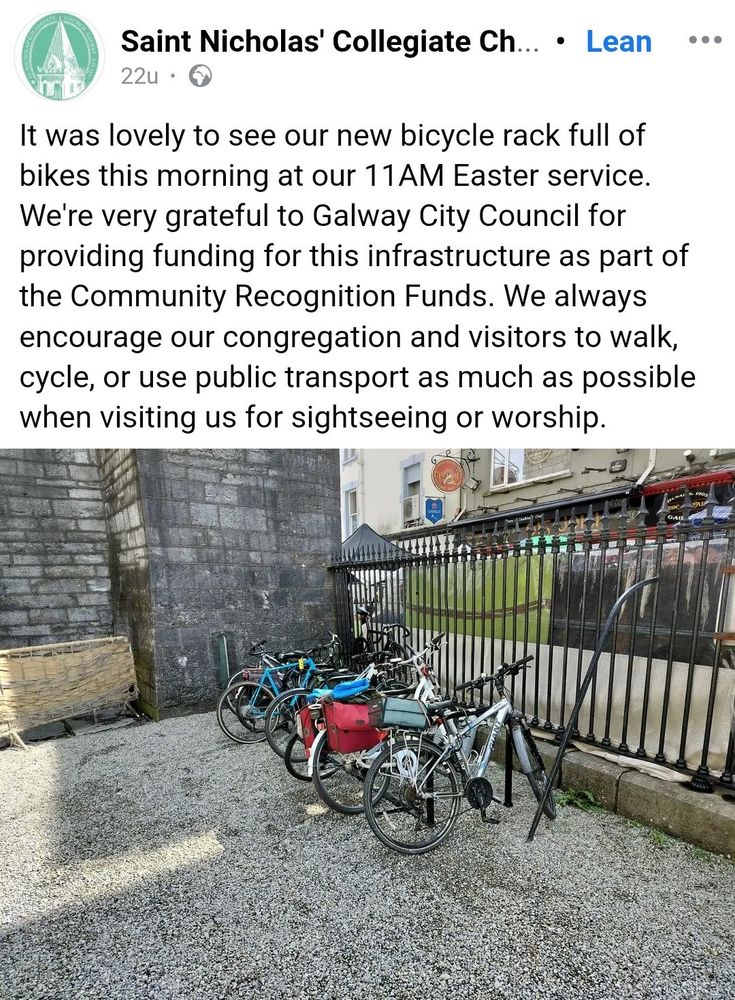 Bike parking inside metal railings of St. Nicholas's Church yard.