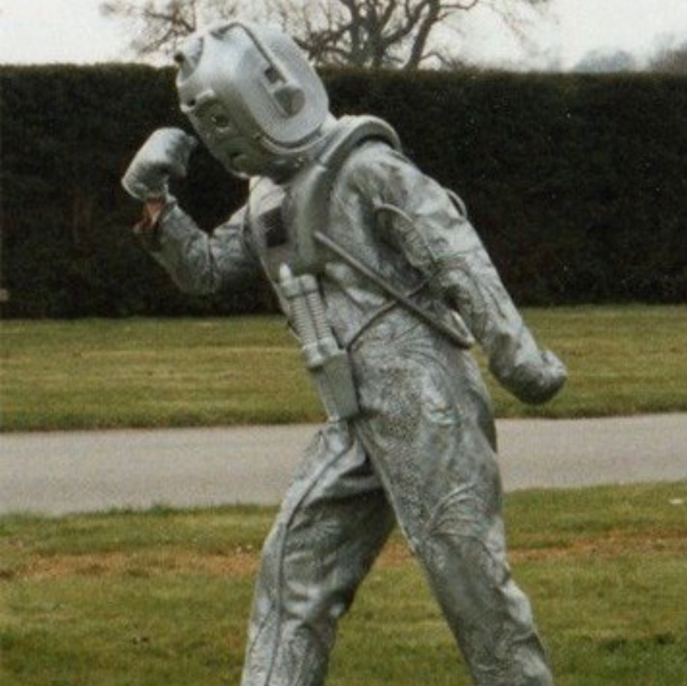 A Cyberman doing a Bruce Forsyth pose.