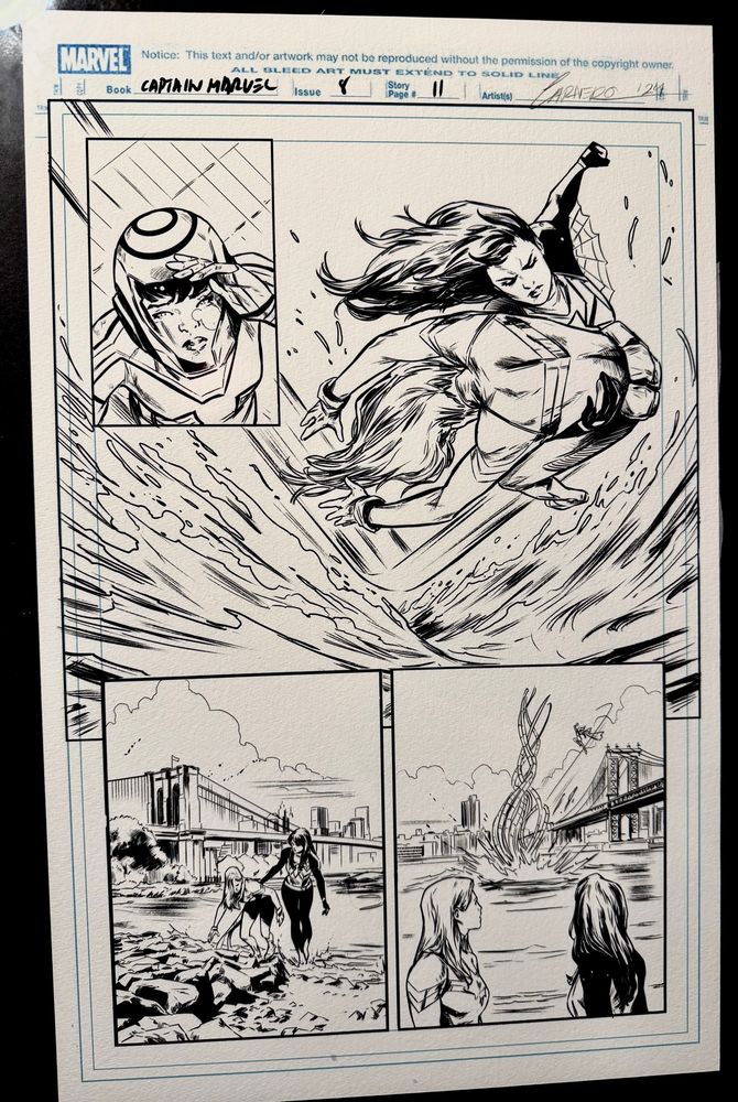 Black-and-white inked comic art labeled Captain Marvel, Issue 8, Page 11, signed by the artist, Carmen Carnero. In the top left panel, Captain Marvel is shown struggling and shielding her face as water crashes around her. The large top-right panel depicts Spider-Woman diving powerfully into the water while holding Captain Marvel tightly, rescuing her in mid-plunge. The bottom left panel shows the two women emerging onto a rocky shoreline beneath a large suspension bridge, Spider-Woman supporting the weakened Captain Marvel. In the bottom middle panel, a towering spiral of energy erupts from the river near another bridge. The bottom right panel shows Spider-Woman and Captain Marvel standing side by side at the waterfront, watching the distant explosion.