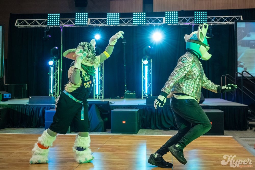 Tommy chasing Typo at Eufuria 2025's Fursuit Dance Competition.