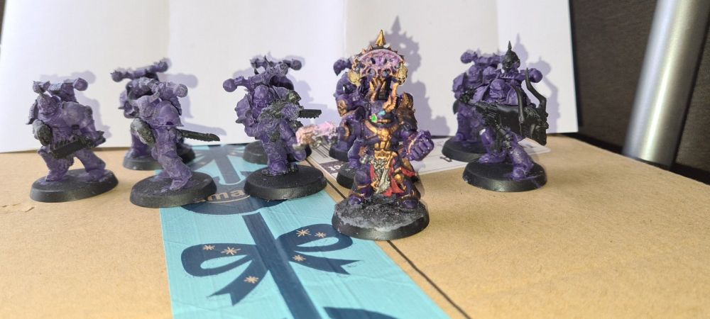 Some converted Chaos Space marines painted in a rich purple representing noise marines with bolters replaced with sonic blasters using skills and greenstuff to make the barrels.