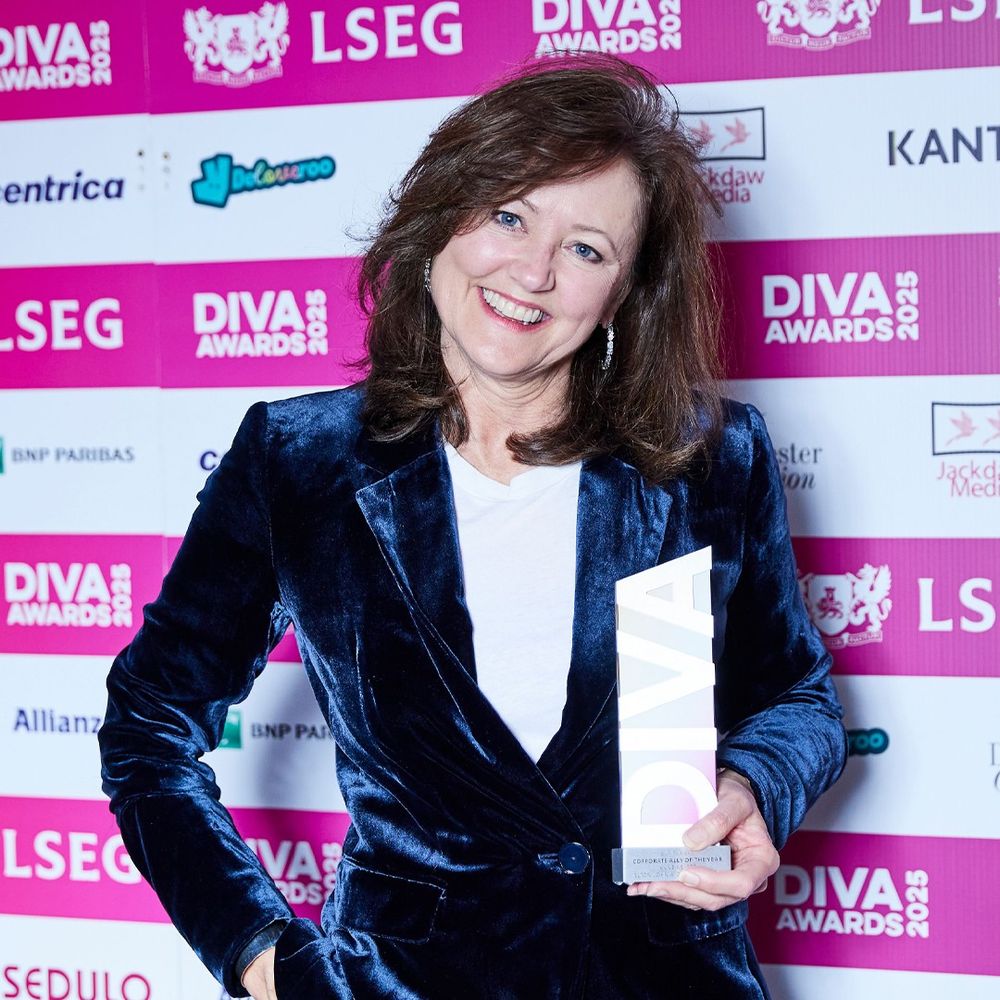 Anne Aslett smiles holding 'Corporate Ally of the Year' award at DIVA Awards 2025.