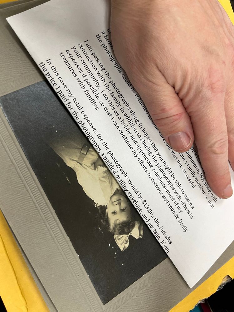 Hand covering a typed letter that is obscuring most of a black and white photo of a girl. Visible text of letter reads: I am passing the photographs along in hopes that you might be able to make a connection with the family in addition to sharing the photographs with others in your community. I do this as a hobby and appreciate reimbursement of my expenses if possible, so that I can continue my efforts to recover and reunite family treasures with families.
In this case my total expenses for the photographs would be $13.00.; this includes the price I paid for the photographs, a padded mailing envelope, and postage.