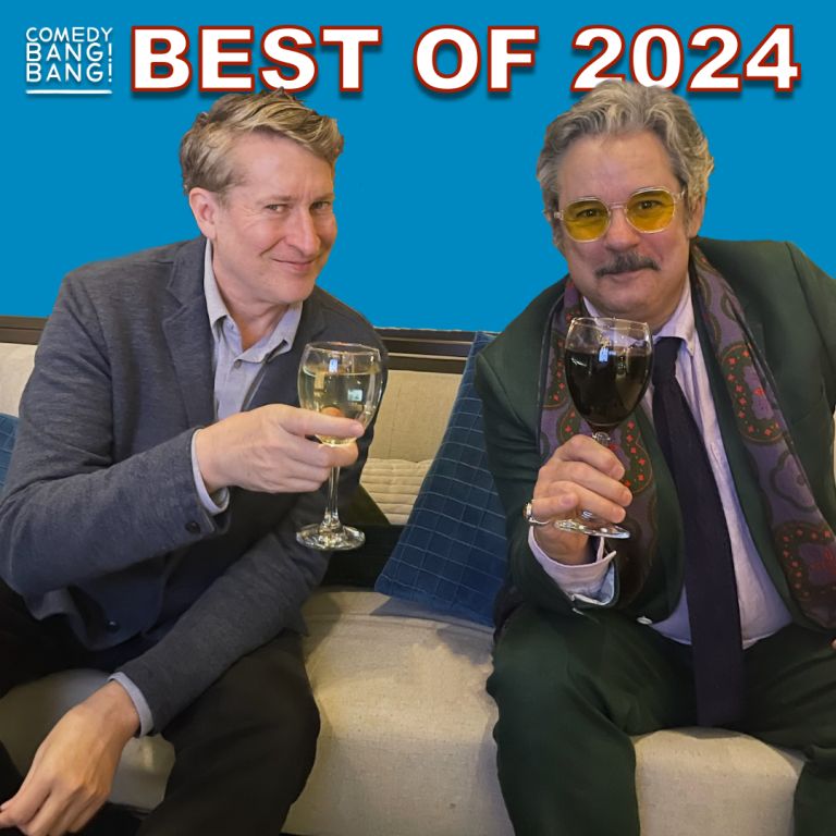 Scott and Paul holding wine glasses like they might cheers or get tipsy and argue about the music man. 
