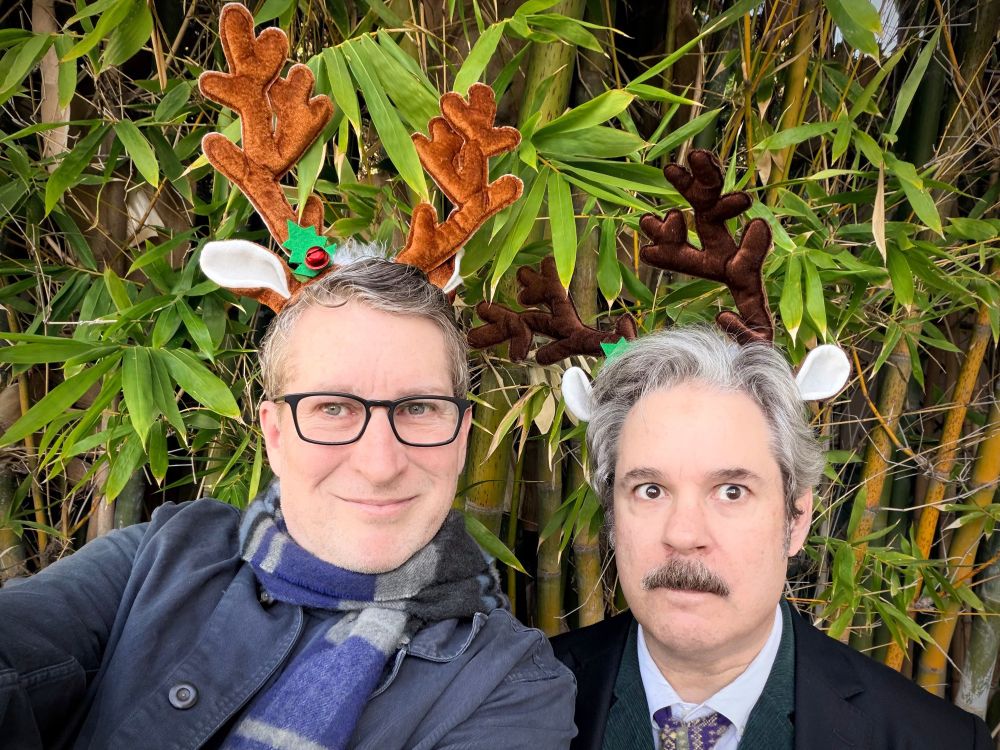 Scott and Paul in antlers outside in their natural habitat 