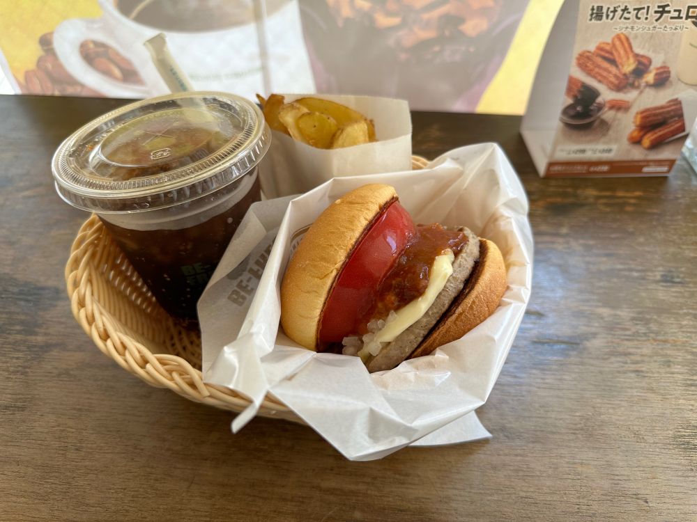 A burger, fries, and a drink in a basket