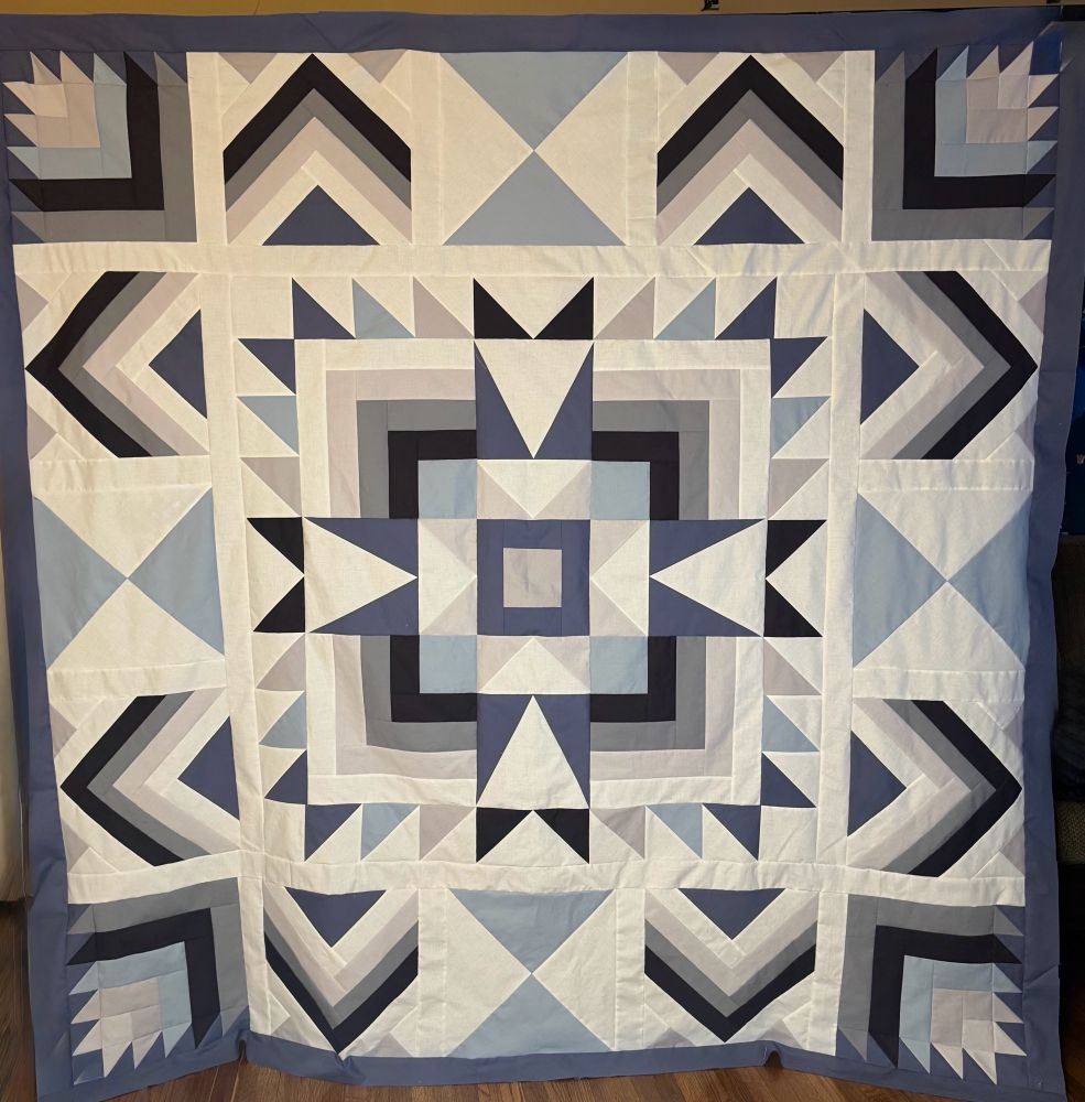 Joplin quilt using Kona Solids: Slate, Shadow, fog, Snow, Silver, Overcast, Charcoal.  Medallion style with chevrons and triangles