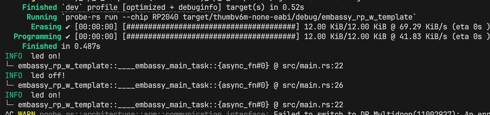 Terminal screenshot showing the output of a Rust program being flashed to an RP2040 chip using probe-rs. The process includes steps for erasing and programming, which complete successfully in 0.487 seconds. The output logs indicate toggling of an LED ('led on!' and 'led off!') at specific lines of src/main.rs. A warning appears at the bottom related to switching to DP Multidrop, signaling a communication issue.