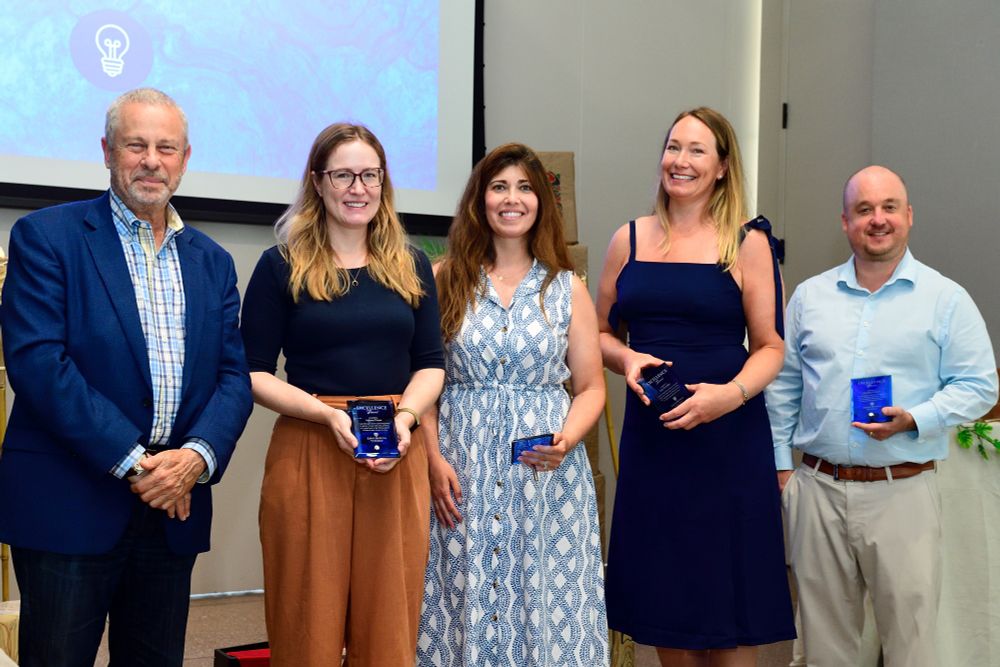 Kim Franklin and other staff members pose with their awards next to Dean Ed Schlesinger.