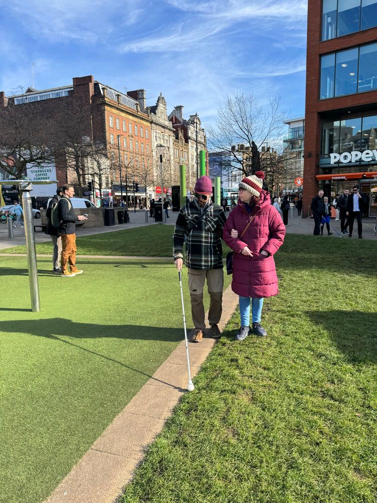 SLC member Mary walking with a landscape architect in Piccadilly Gardens 