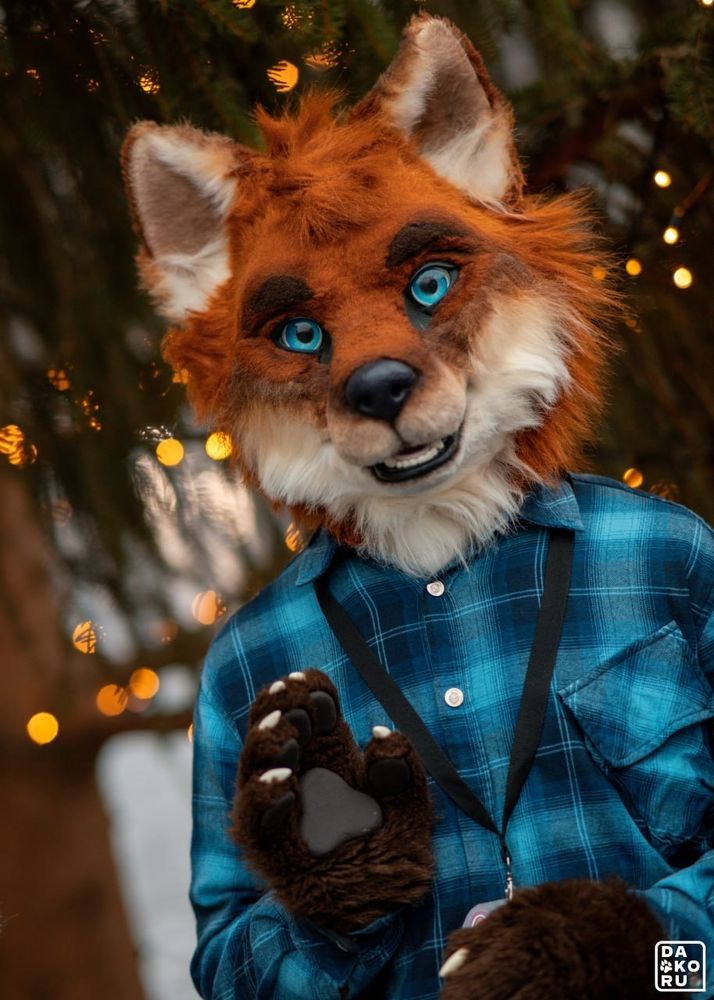 Fox fursuit waving to the camera