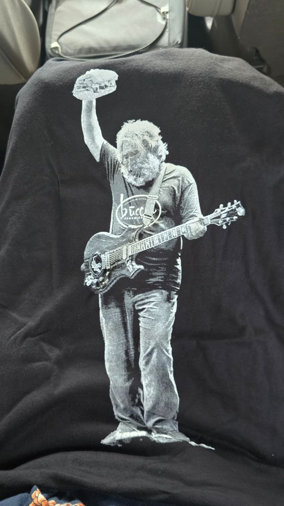 Jerry Garcia holding a sandwich above his head 