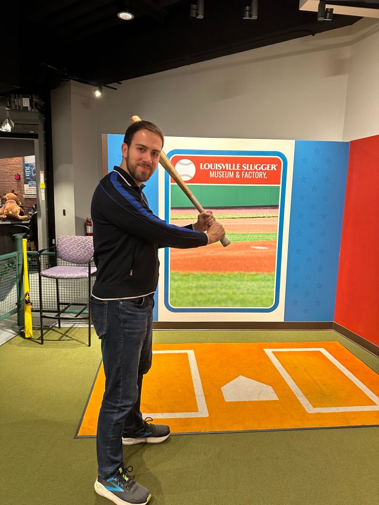 James seen posing in front of a “baseball card” backdrop with one of Roberto Clemente’s bats 