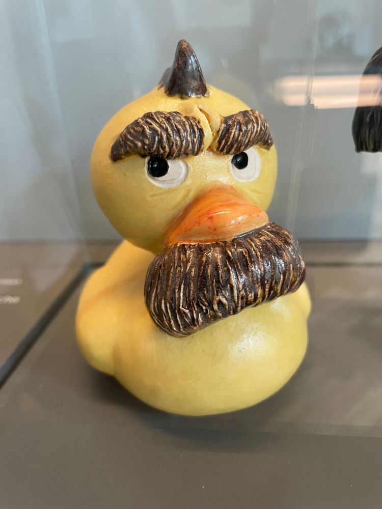 Yellow rubber überduckie styled as Friedrich Nietzsche, with bushy eyebrows and moustache.