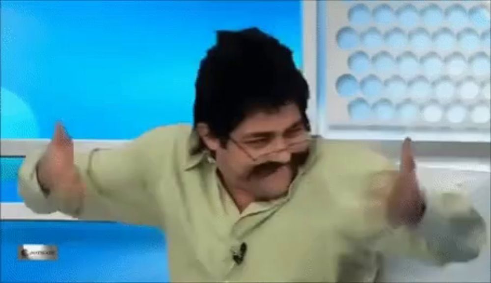 a man with a mustache and glasses is dancing