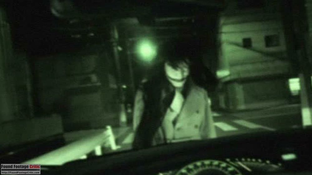 Scene from Kōji Shiraishi's Senritsu Kaiki File Kowasugi File 01: Operation Capture the Slit-Mouthed Woman (2012) of said Slit-Mouthed Woman caught on a night vision cam. Proper scary.
