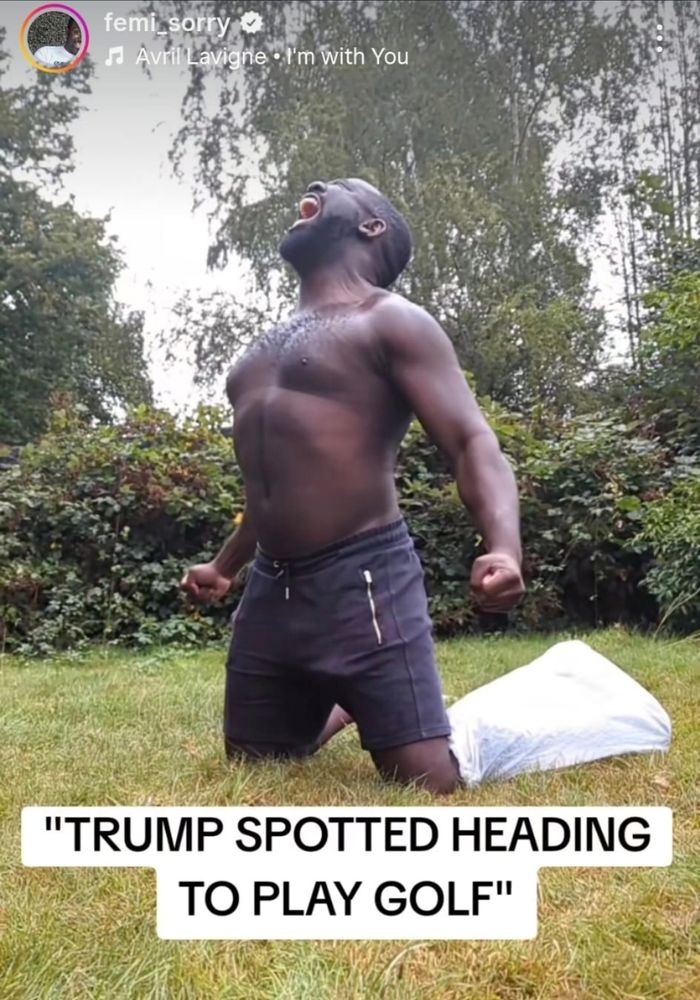 Femi half-naked, on his knees outside, with one leg apparently inside a pillowcase. Caption 