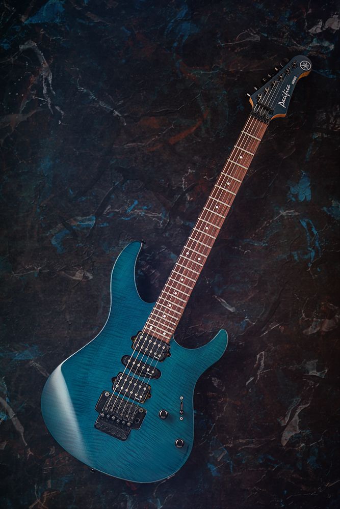 Yamaha Pacifica electric guitar with blue tiger maple body and rosewood fingerboard. Swirling paint dabs and textured background 