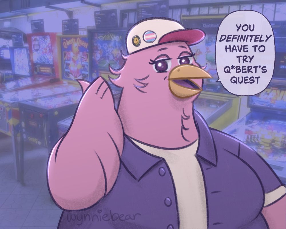 A pink anthropomorphic bird wearing a purple button up shirt and white tee shirt underneath, and a baseball cap with a transgender flag button and smiley face button on it. They are pointing behind themself saying "You definitely have to try Q*bert's Quest" with a row of pinball machines behind them.