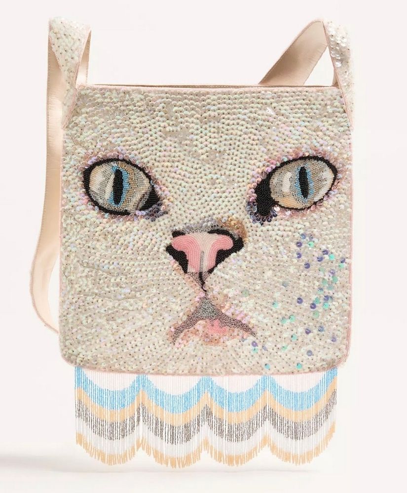 Valentino Garavani tote/shoulder bag of a close-up on a white cat's face, heavily embroidered with sequins. A white, blue, yellow and taupe scalloped-pattern fringe hangs from the base of the bag.