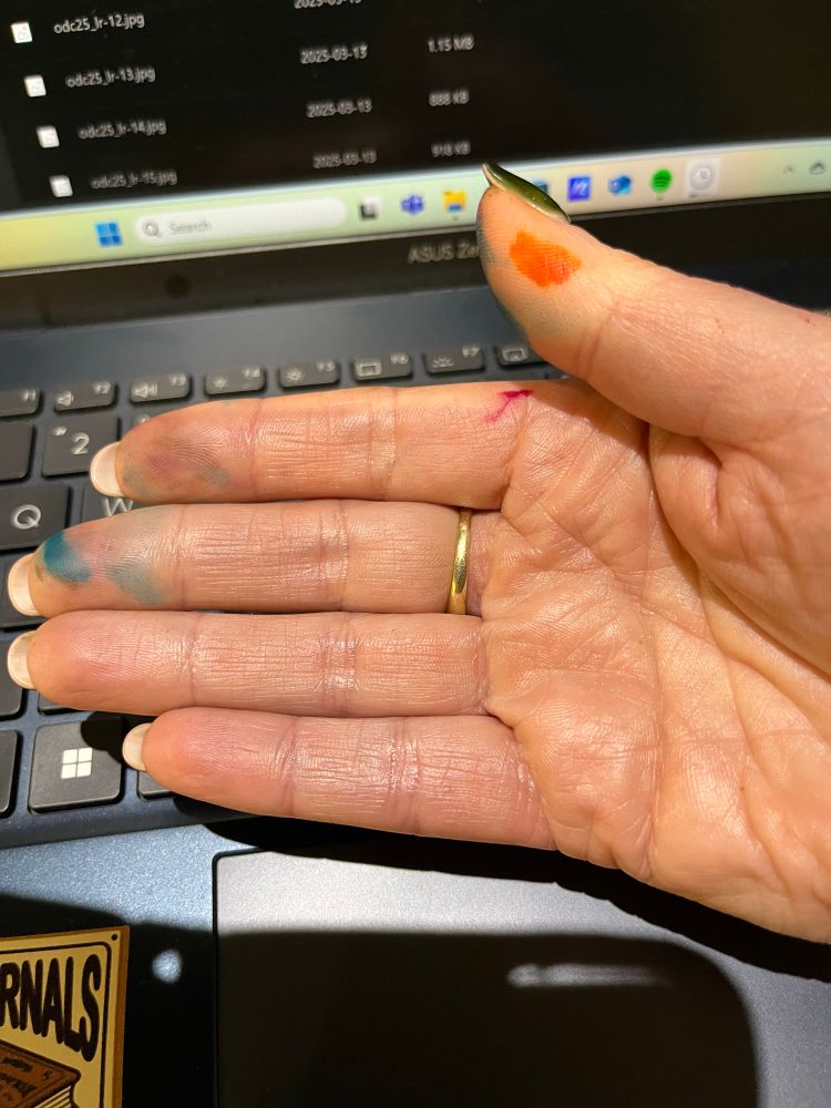 A white right hand with a gold ring. The hand is covered in ink splotches because I’m a clumsy tit. 