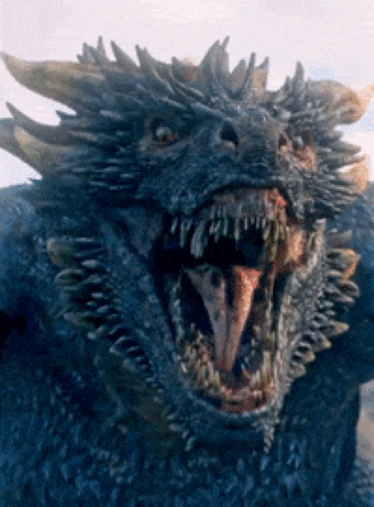 a close up of a dragon with its mouth open and its tongue sticking out