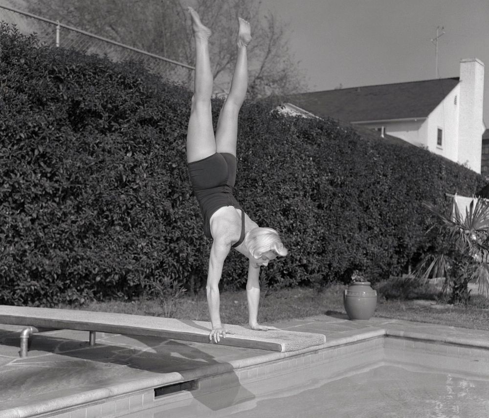 Doris Day doing a handstand on a diving board. Her buttocks are featured 