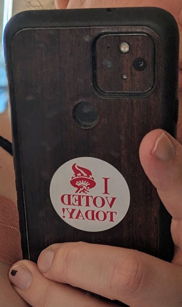 The back of a phone case with an "I voted today" sticker on it 