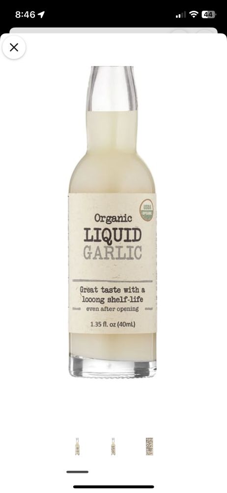 A bottle of opaque white liquid labeled "organic liquid garlic"